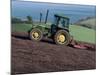 John Deere Tractor with a Rotivator on a Sloping Field in Spring, at Holcombe, Devon, England, UK-Ian Griffiths-Mounted Photographic Print