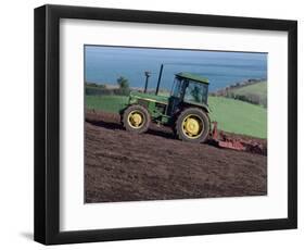 John Deere Tractor with a Rotivator on a Sloping Field in Spring, at Holcombe, Devon, England, UK-Ian Griffiths-Framed Photographic Print