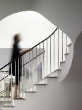 Woman walking up staircase holding handrail-John Edward Linden-Framed Photo