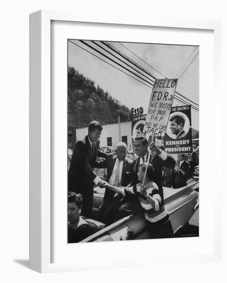 John F. Kennedy and Franklin D. Roosevelt Jr. Shaking Hands with Boy During Parade-Hank Walker-Framed Photographic Print