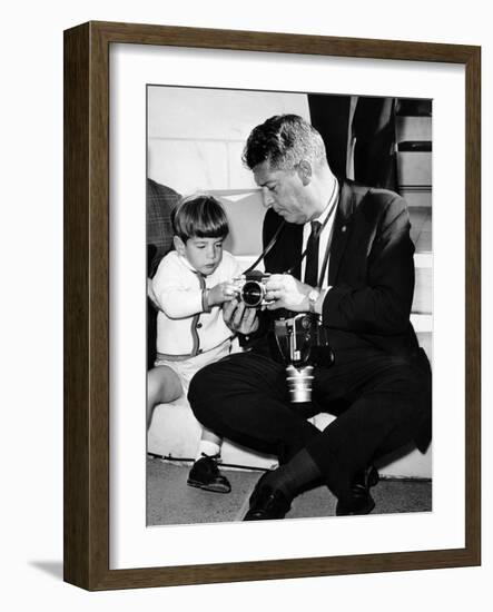 John F Kennedy Jr Looks at Cameras of White House Photographer Capt Cecil Stoughton, Nov 11, 1963-null-Framed Photo