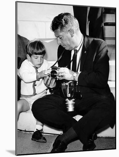 John F Kennedy Jr Looks at Cameras of White House Photographer Capt Cecil Stoughton, Nov 11, 1963-null-Mounted Photo