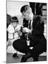 John F Kennedy Jr Looks at Cameras of White House Photographer Capt Cecil Stoughton, Nov 11, 1963-null-Mounted Photo