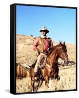 John Wayne on horse in mountains-Movie Star News-Framed Stretched Canvas