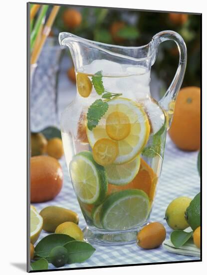 Jug of Water with Citrus Fruit, Lemon Balm and Ice Cubes-F. Strauss-Mounted Photographic Print