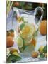 Jug of Water with Citrus Fruit, Lemon Balm and Ice Cubes-F. Strauss-Mounted Photographic Print