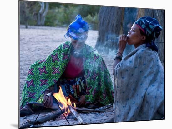 Jul'Hoan !Kung Bushman, Two Women Smoke around Fire in Village, Bushmanland, Namibia-Kim Walker-Mounted Photographic Print