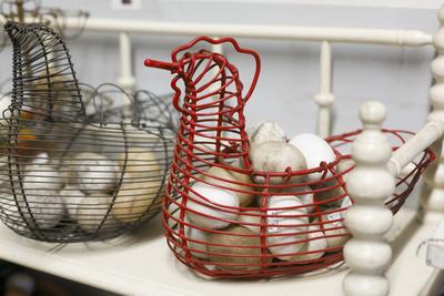 Chicken-shaped metal baskets holding rocks.