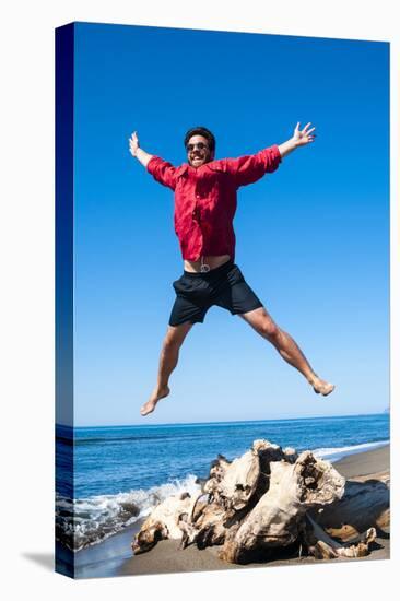 Jumping close to sea, Capalbio beach, province of Grosseto, Tuscany, Italy, Europe-Nico Tondini-Stretched Canvas