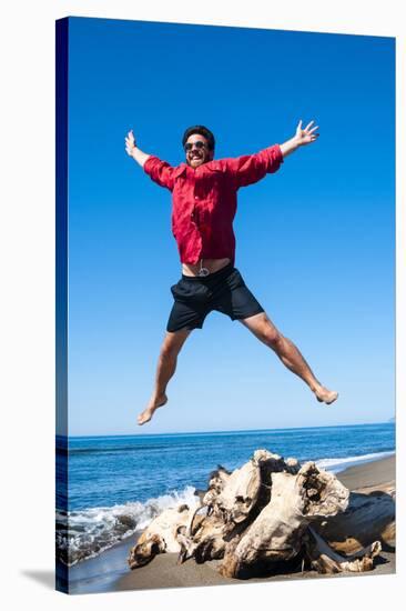 Jumping close to sea, Capalbio beach, province of Grosseto, Tuscany, Italy, Europe-Nico Tondini-Stretched Canvas