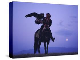 Kalanash Sarsembek with Eagle, a Hunter's Moonrise Over Steppe, Kazakhstan, Central Asia-David Beatty-Stretched Canvas