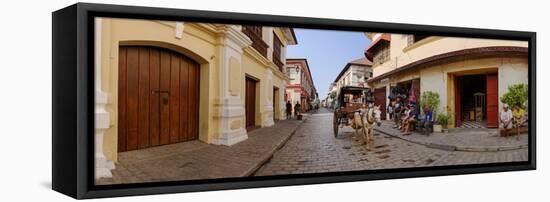 Kalesa moving along Calle Crisologo, Vigan, Ilocos Sur, Philippines-null-Framed Stretched Canvas