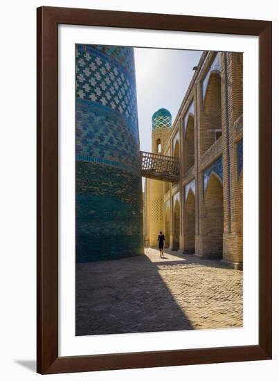 Kalta Minor minaret, Khiva. Uzbekistan, Central Asia. Woman walking near the minaret.-ClickAlps-Framed Photographic Print