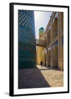 Kalta Minor minaret, Khiva. Uzbekistan, Central Asia. Woman walking near the minaret.-ClickAlps-Framed Photographic Print