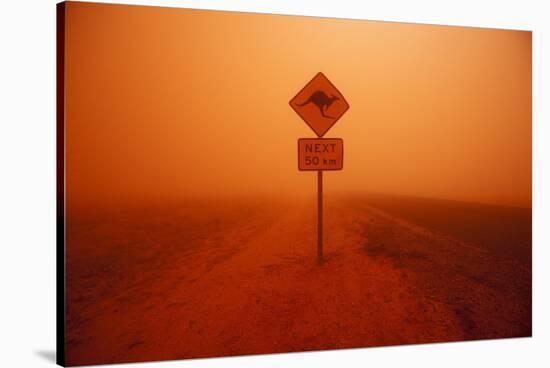 Kangaroo Crossing Sign in Dust Storm in the Australian Outback-Paul Souders-Stretched Canvas