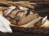 A Rustic Country Loaf on a Slice of Wood-Karl Newedel-Photographic Print