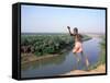Karo Boy Leaps Off a Cliff Over the Omo River, Ethiopia-Janis Miglavs-Framed Stretched Canvas