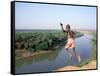 Karo Boy Leaps Off a Cliff Over the Omo River, Ethiopia-Janis Miglavs-Framed Stretched Canvas