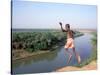 Karo Boy Leaps Off a Cliff Over the Omo River, Ethiopia-Janis Miglavs-Stretched Canvas