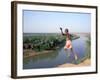 Karo Boy Leaps Off a Cliff Over the Omo River, Ethiopia-Janis Miglavs-Framed Photographic Print