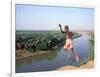 Karo Boy Leaps Off a Cliff Over the Omo River, Ethiopia-Janis Miglavs-Framed Photographic Print