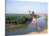Karo Boy Leaps Off a Cliff Over the Omo River, Ethiopia-Janis Miglavs-Stretched Canvas