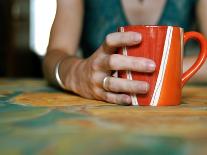 A Hand Holding a Red Mug-Katrin Adam-Photographic Print