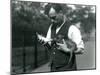 Keeper Harry Warwick Bottle Feeds a Baby Warthog at London Zoo, in August 1922-Frederick William Bond-Mounted Photographic Print