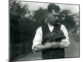 Keeper Harry Warwick Cradles a Baby Warthog in His Arms at London Zoo, August 1922-Frederick William Bond-Mounted Photographic Print