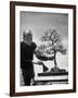 Keibun Tanaka Brushing Away Fallen Leaves of a Bonsai Maple Tree in Garden, Suburban Tokyo-Alfred Eisenstaedt-Framed Premium Photographic Print