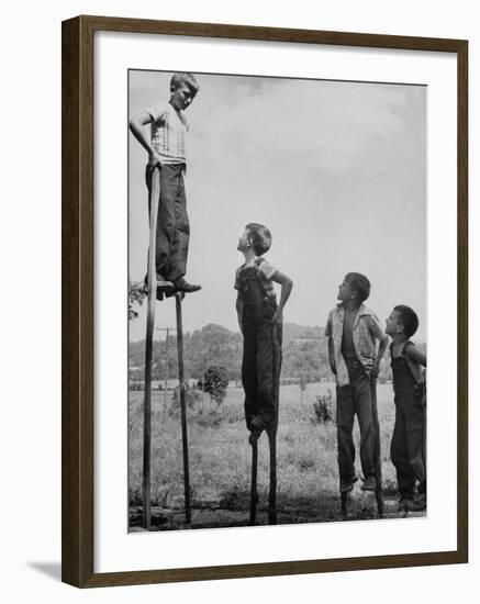 Kenneth Merriman on higher stilts than his brothers and friend-Robert W^ Kelley-Framed Photographic Print