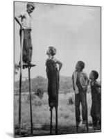 Kenneth Merriman on higher stilts than his brothers and friend-Robert W^ Kelley-Mounted Photographic Print