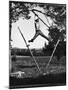 Kenneth Merriman Swinging on Tree Limb After Kicking Away Stilts-Robert W^ Kelley-Mounted Photographic Print