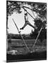 Kenneth Merriman Swinging on Tree Limb After Kicking Away Stilts-Robert W^ Kelley-Mounted Photographic Print