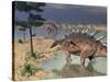 Kentrosaurus Dinosaurs Walking in the Water Next to Sand and Trees-null-Stretched Canvas