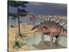 Kentrosaurus Dinosaurs Walking in the Water Next to Sand and Trees-null-Stretched Canvas