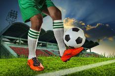 Foot Ball Player Holding Foot Ball on Leg Ankle on Soccer Sport Field Agianst Stadium and Dusky Sky-khunaspix-Photographic Print