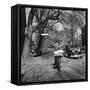 Kid Football Player Delivering Newspapers-Francis Miller-Framed Stretched Canvas