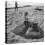 Kid Playing in Sand-Martha Holmes-Stretched Canvas