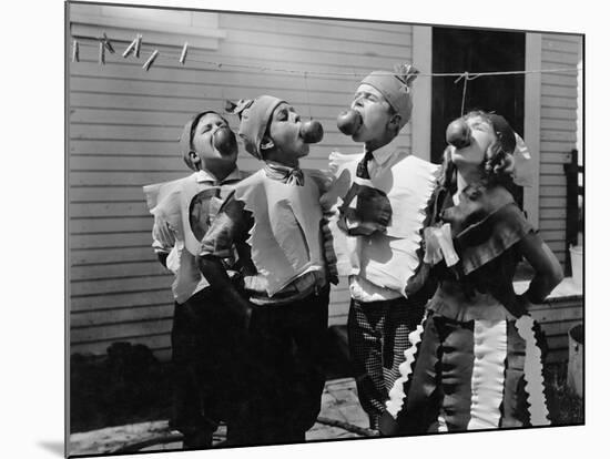 Kids Biting Apples on Strings at Halloween-null-Mounted Photo
