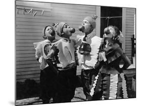 Kids Biting Apples on Strings at Halloween-null-Mounted Photo