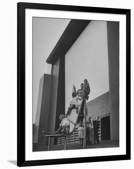 Kids Enjoying Slide in Mini Playground in Front of Rancho Drive-Allan Grant-Framed Photographic Print