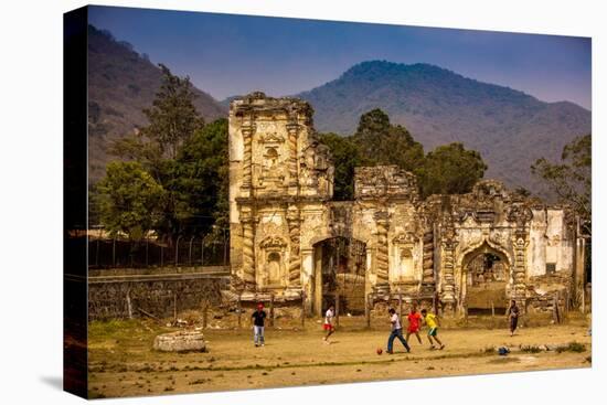 Kids Playing Soccer at Ruins in Antigua, Guatemala, Central America-Laura Grier-Stretched Canvas