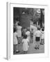 Kids Watching Outdoor Puppet Show-Dmitri Kessel-Framed Photographic Print