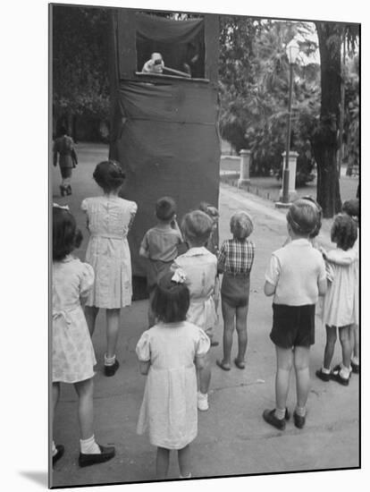 Kids Watching Outdoor Puppet Show-Dmitri Kessel-Mounted Photographic Print