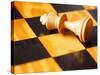 King chess piece lying on chessboard-null-Stretched Canvas