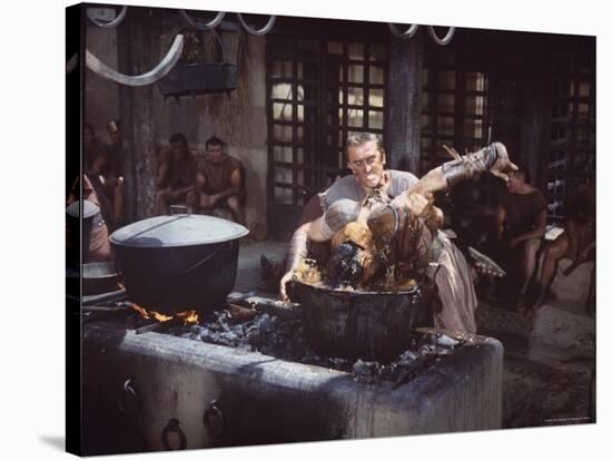 Kirk Douglas Dunking Enemy's Head in Giant Cook Pot in Scene From Stanley Kubrick's "Spartacus"-J^ R^ Eyerman-Stretched Canvas