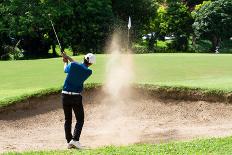Thai Young Man Golf Player in Action Swing in Sand Pit during Practice before Golf Tournament at Go-Kitzero-Photographic Print