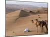 Kneeling to Pray in Desert, Holding Camels by Halters to Prevent Them Wandering Off Amongst Dunes-John Warburton-lee-Mounted Photographic Print