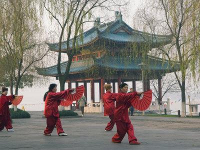 Women Practising Tai Chi in Front of a Pavilion on West Lake, Hangzhou, Zhejiang Province, China